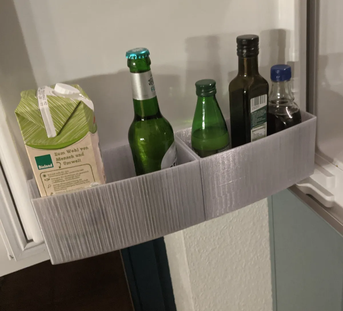 Gancho de sujeción para bandeja de heladera