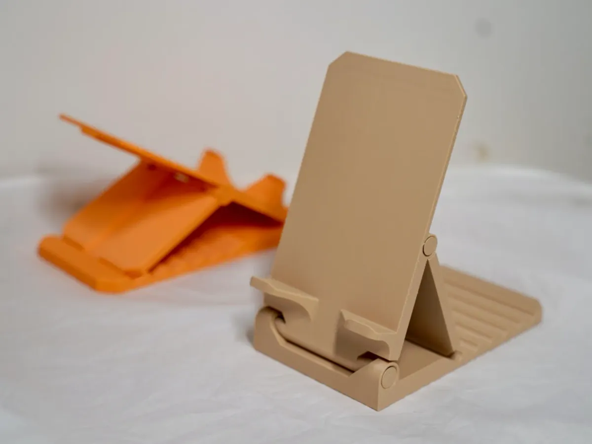 Soporte de celular plegable de una pieza