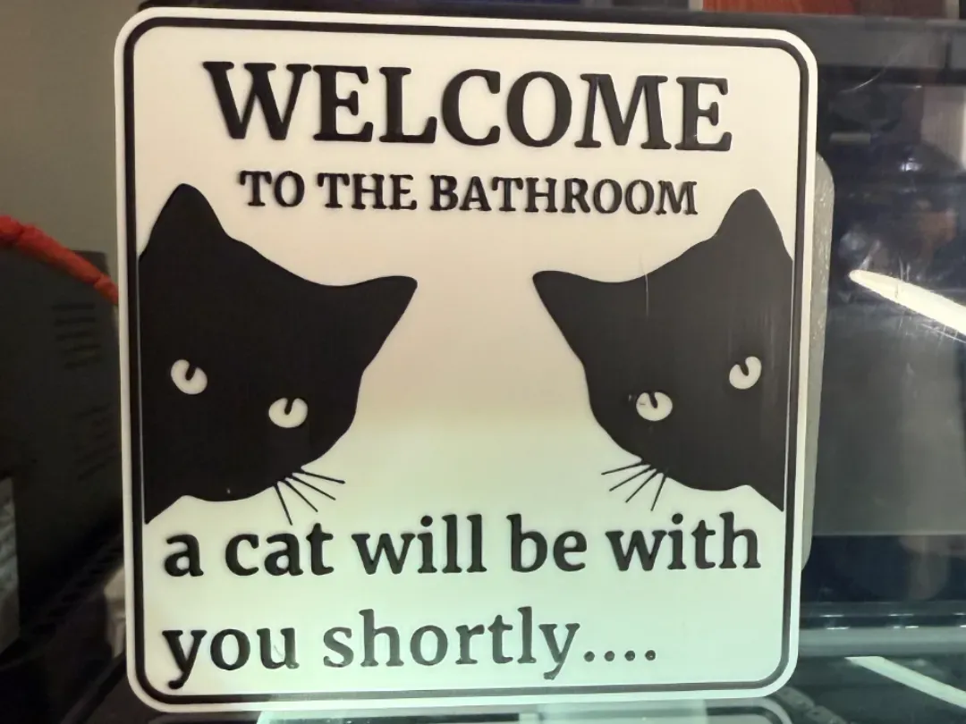 Cartel de baño con silueta de gato