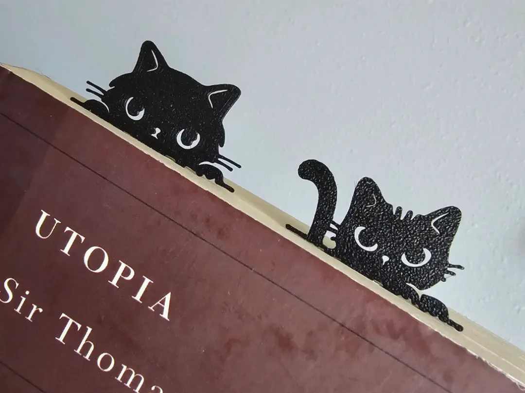 Señalador de gato asomado entre las hojas