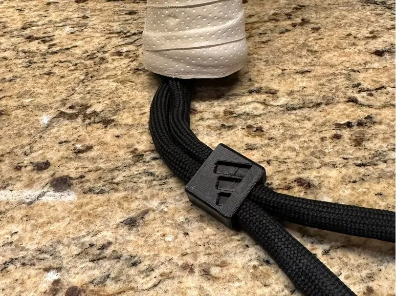 Ajustador del cordón de muñeca de la pala