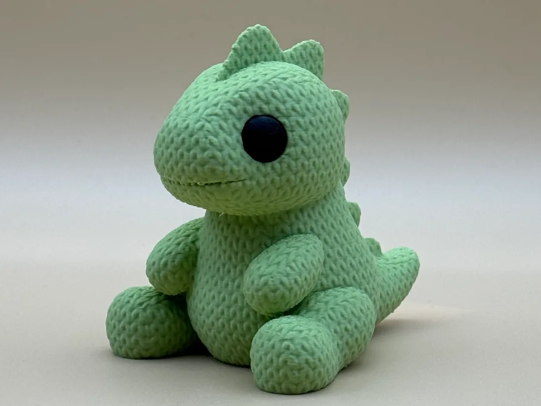 Dinosaurio bebé con textura de tejido