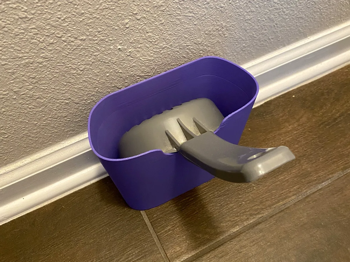 Soporte para la pala de la arena del gato